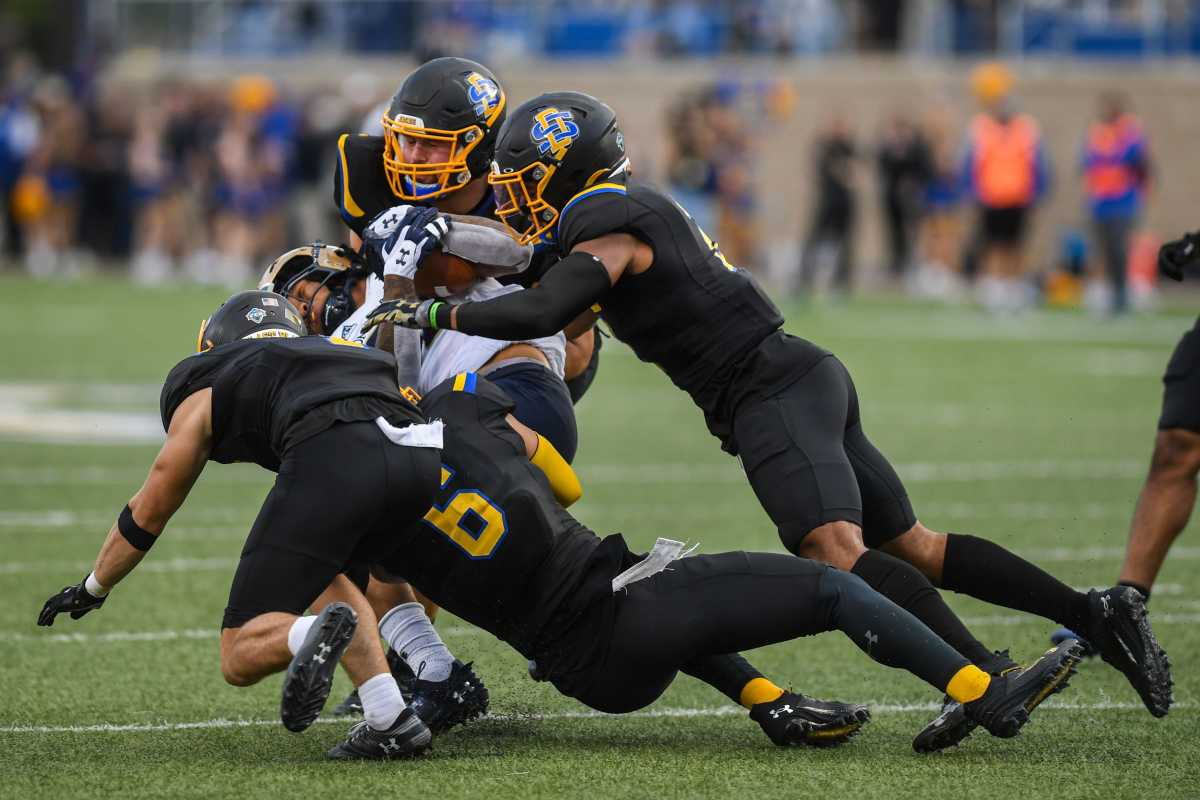South Dakota State football players try to tackle a Montana State player at Dana J. Dykhouse Stadium in Brookings, South Dakota on Saturday, Sept. 9, 2023.